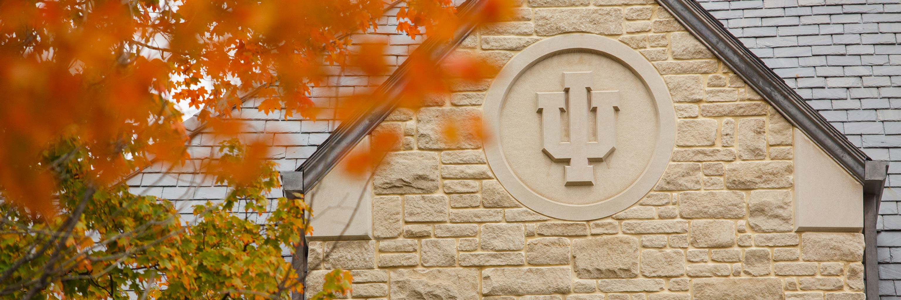 Indiana University seal carved into the side of a building